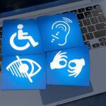 Accessibility icons for mobility, hearing, vision and communication on a laptop, representing inclusive digital access