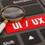 User Interface User Experience Concept UI/UX Key on Computer Keyboard with a Magnifier